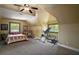 Spacious bedroom features carpet, a ceiling fan, and two windows allowing lots of natural light at 707 S Dixie Dr, Howey In The Hills, FL 34737