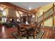 Elegant dining area with wood floors, a stone fireplace, and easy access to the living room at 707 S Dixie Dr, Howey In The Hills, FL 34737
