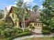 Beautiful two-story home featuring lush landscaping, a chimney, and multiple windows at 707 S Dixie Dr, Howey In The Hills, FL 34737