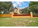 Side view of home showcasing architecture, chimney, backyard and fence at 707 S Dixie Dr, Howey In The Hills, FL 34737
