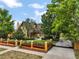 Expansive landscaped yard, red-trimmed home, and gated entrance creates a luxury, private retreat at 707 S Dixie Dr, Howey In The Hills, FL 34737