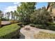 Landscaped front yard featuring a stone paver walkway and manicured boxwood hedges at 707 S Dixie Dr, Howey In The Hills, FL 34737