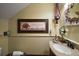 Cozy half-bathroom featuring beadboard paneling, vanity, and decorative artwork at 707 S Dixie Dr, Howey In The Hills, FL 34737