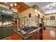 Kitchen with a center island cooktop, green cabinetry, and wooden countertops at 707 S Dixie Dr, Howey In The Hills, FL 34737