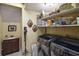 Convenient laundry room with modern machines, sink, and ample storage shelves at 707 S Dixie Dr, Howey In The Hills, FL 34737