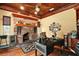 Cozy home office with a brick fireplace, tin ceiling, and a large desk for productivity at 707 S Dixie Dr, Howey In The Hills, FL 34737