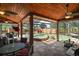 Covered patio with ceiling fans, outdoor dining furniture, and a view of the screened in pool at 707 S Dixie Dr, Howey In The Hills, FL 34737