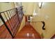 View of the wooden staircase featuring a decorative railing and wall sconces for added ambiance at 707 S Dixie Dr, Howey In The Hills, FL 34737