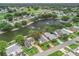 Beautiful home with lake view, mature trees, fountain and golf course in distance at 727 Turnberry Ln, The Villages, FL 32159