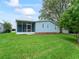 Charming home featuring a screened lanai and a lush, green backyard, perfect for outdoor relaxation at 727 Turnberry Ln, The Villages, FL 32159