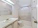 Bathroom boasts vanity with sink, tiled floors, and enclosed shower with translucent glass at 727 Turnberry Ln, The Villages, FL 32159