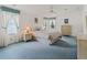 Cozy bedroom featuring soft lighting, a large bed, coordinated decor, and drapery accenting the large double windows at 727 Turnberry Ln, The Villages, FL 32159