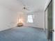 Bright bedroom features light blue carpet, ceiling fan, and sliding door closet at 727 Turnberry Ln, The Villages, FL 32159