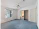Open bedroom features light blue carpet, ceiling fan, and sliding door closet at 727 Turnberry Ln, The Villages, FL 32159