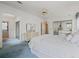 Comfortable bedroom features a spacious closet, coordinated furniture, plush carpeting, and access to the en suite bathroom at 727 Turnberry Ln, The Villages, FL 32159