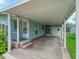 Covered carport offers protection from the elements and additional outdoor living space at 727 Turnberry Ln, The Villages, FL 32159