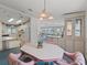 Open floor plan featuring an eat-in kitchen, and a dining room with decorative lighting, built in cabinetry, and seating for four at 727 Turnberry Ln, The Villages, FL 32159