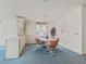 Open dining room with white walls, neutral carpeting, and seating for four at 727 Turnberry Ln, The Villages, FL 32159
