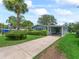 Well-maintained home with carport, manicured lawn, and lush landscaping at 727 Turnberry Ln, The Villages, FL 32159