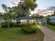 Charming home with a well-manicured lawn and tropical landscaping at 727 Turnberry Ln, The Villages, FL 32159