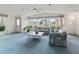 Bright, airy living room features large windows and comfortable floral patterned sofas at 727 Turnberry Ln, The Villages, FL 32159