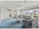 Open living room with lots of natural light and comfortable floral patterned sofas at 727 Turnberry Ln, The Villages, FL 32159