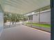 Enclosed porch featuring water view through walls of screened windows and door at 727 Turnberry Ln, The Villages, FL 32159