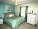 Comfortable bedroom with a queen bed, side table and bright, natural light at 751 Old Oaks Ln, Leesburg, FL 34748