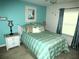 Comfortable bedroom with a queen bed, ceiling fan, and bright, natural light at 751 Old Oaks Ln, Leesburg, FL 34748