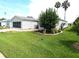 Single-story home with lush green lawn and well-maintained landscaping at 751 Old Oaks Ln, Leesburg, FL 34748
