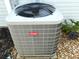 Close-up of a Bryant HVAC unit with surrounding rocks and foliage at 751 Old Oaks Ln, Leesburg, FL 34748