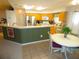 Spacious kitchen with stainless steel appliances and adjacent breakfast nook at 751 Old Oaks Ln, Leesburg, FL 34748