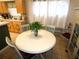 Eat-in kitchen with a round table, neutral tile floor and wood cabinets at 751 Old Oaks Ln, Leesburg, FL 34748