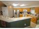 Well-lit kitchen with stainless steel appliances and a convenient breakfast bar at 751 Old Oaks Ln, Leesburg, FL 34748