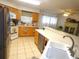 Bright kitchen featuring tile floors and ample counter space at 751 Old Oaks Ln, Leesburg, FL 34748