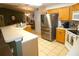 Bright kitchen featuring stainless steel refrigerator and tiled flooring at 751 Old Oaks Ln, Leesburg, FL 34748
