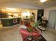 Comfortable living room with vaulted ceilings, opening to the kitchen and dining area at 751 Old Oaks Ln, Leesburg, FL 34748