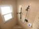 Bathroom shower featuring a handheld shower head, built-in seat, and tiled walls at 751 Old Oaks Ln, Leesburg, FL 34748