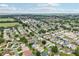 Expansive aerial view of a vibrant residential community with lush greenery, lakes and well-maintained homes at 8039 Se 174Th Belhaven Loop, The Villages, FL 32162