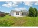Grassy backyard with patio, screened-in porch and beautifully landscaped at 8039 Se 174Th Belhaven Loop, The Villages, FL 32162