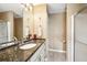 Bathroom with white cabinets, granite countertops, shower, and brushed nickel faucet at 8039 Se 174Th Belhaven Loop, The Villages, FL 32162