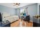 Comfortable bedroom with desk area, wood floors, and window providing natural light at 8039 Se 174Th Belhaven Loop, The Villages, FL 32162