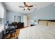 Bedroom features desk area, wood floors, and ample closet space at 8039 Se 174Th Belhaven Loop, The Villages, FL 32162