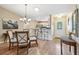 Dining area with stylish furnishings, leading to the kitchen and front entrance at 8039 Se 174Th Belhaven Loop, The Villages, FL 32162