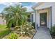 Charming home entrance featuring a well-manicured garden and a decorative glass front door at 8039 Se 174Th Belhaven Loop, The Villages, FL 32162