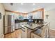 Bright kitchen features stainless steel appliances, granite countertops, and a breakfast bar with seating at 8039 Se 174Th Belhaven Loop, The Villages, FL 32162
