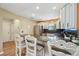 Open kitchen features bar seating, stainless appliances, granite counters, and ample storage at 8039 Se 174Th Belhaven Loop, The Villages, FL 32162
