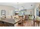 Living room with a granite kitchen counter, a ceiling fan, and an open layout at 8039 Se 174Th Belhaven Loop, The Villages, FL 32162