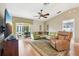 Cozy living room with a ceiling fan and sliding glass doors to the outdoor space at 8039 Se 174Th Belhaven Loop, The Villages, FL 32162