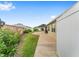 Landscaped backyard featuring a well-manicured lawn, planted beds, and a spacious patio at 832 Parrish Pl, The Villages, FL 32163